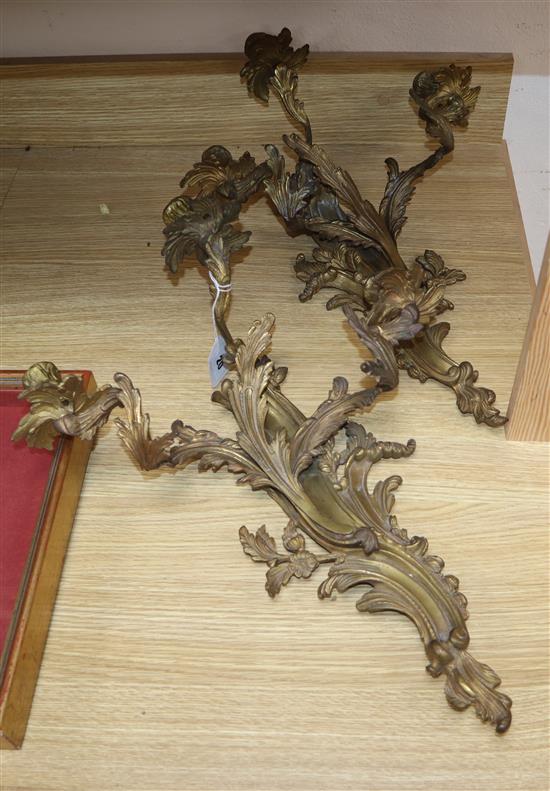 A pair of gilt metal three branch wall sconces